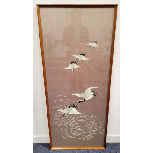 528 - LARGE SILK EMBROIDERY OF FLYING CRANES
on brown ground with mountain in back ground framed and glaze... 