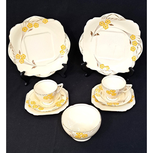 249 - GRAFTON CHINA 'FANTASY' PATTERN TEA SET
with yellow flowers on a cream ground, comprising eleven cup... 