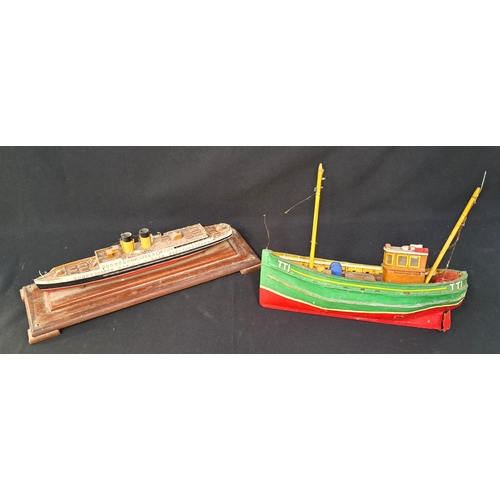 362 - TWO MODEL BOATS
comprising a model of a passenger liner on stand, 36cm long; and a green and red fis... 