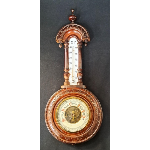 397 - EDWARDIAN ANEROID MAHOGANY BAROMETER 
with ornate carving, 50cm long