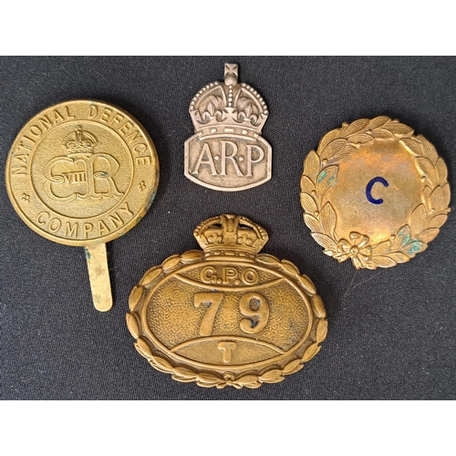 476 - SELECTION OF FOUR BADGES 
comprising National Defence Company cap badge, Coach Company cap badge, Ge... 