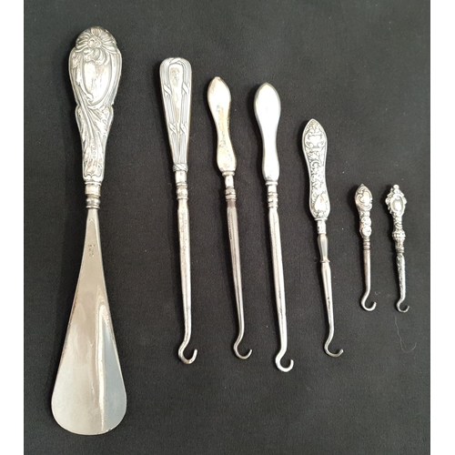 246 - SIX SILVER HANDELED BUTTON HOOKS AND SHOE HORN
all with Birmingham hallmarks, the earliest date 1899... 