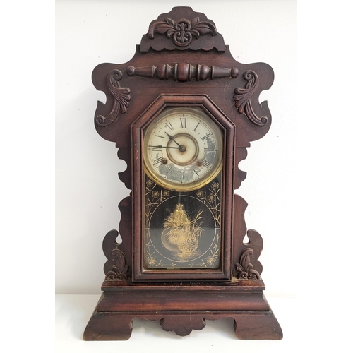 382 - AN AMERICAN GINGERBERAD MANTLE CLOCK BY NEW HAVEN
with Mahogany case and foliate and swag details, t... 