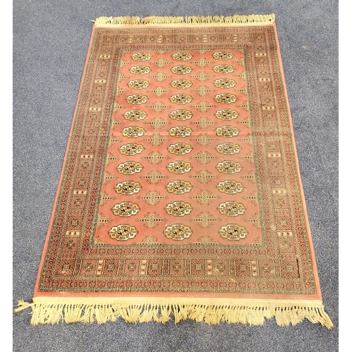 636 - BOKHARA STYLE RUG
on pink ground with fringing, 119 x 170cm