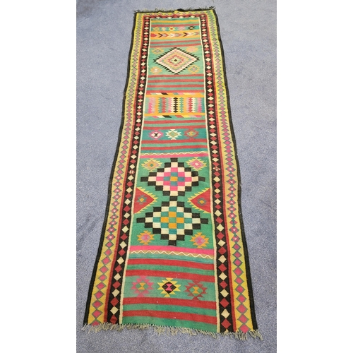 641 - TURKISH KILIM STYLE WOOLLEN RUNNER
of bright coloured geometric patterns, 105 x 343cm