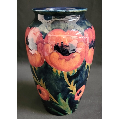 299 - MOORCROFT 'BIG POPPY' PATTERN VASE, CIRCA 1925 
the navy blue ground with flowers decorated in orang... 