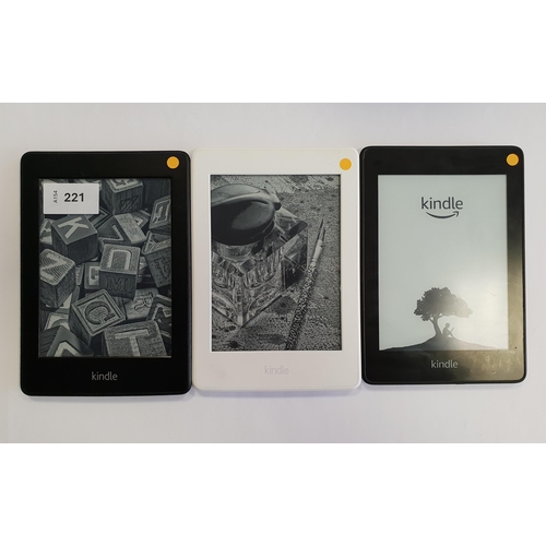 221 - THREE AMAZON KINDLE PAPERWHITE E-READERS
comprising a Paperwhite 4, serial number G000 PP12 9204 01E... 