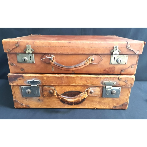 407 - TWO VINTAGE LEATHER SUITCASSES
both with reinforced corners, one with internal straps and satchel co... 