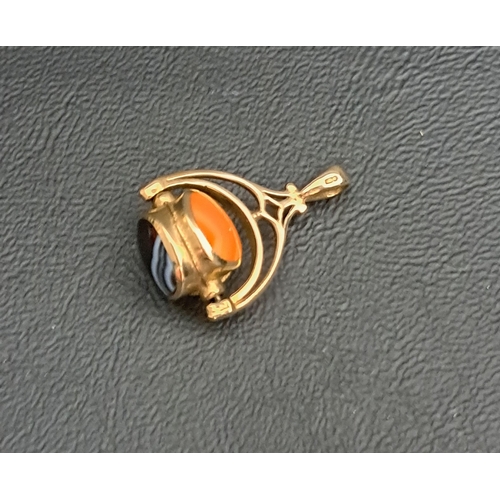 23 - AGATE SET SWIVEL FOB
in nine carat gold, 2.7cm long and approximately 3.9 grams