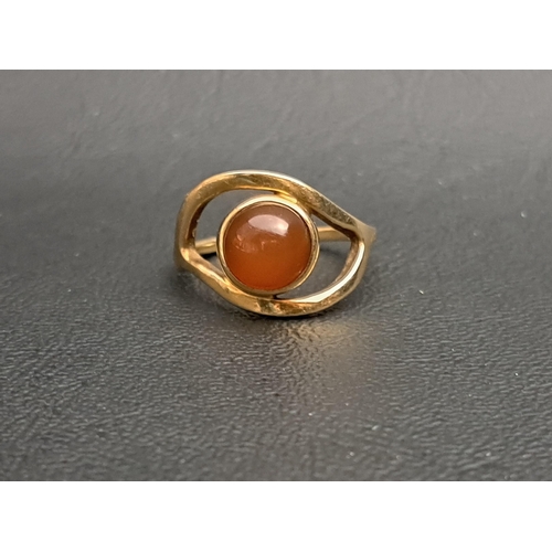 27 - UNUSUAL OLA GORIE CABOCHON CARNELIAN SET RING
in shaped and pierced setting and on nine carat gold s... 