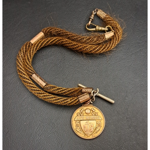 199 - NINE CARAT GOLD MEDAL FOB
one side with a boat decorated shield below a banner reading 'LIFE MEMBER'... 