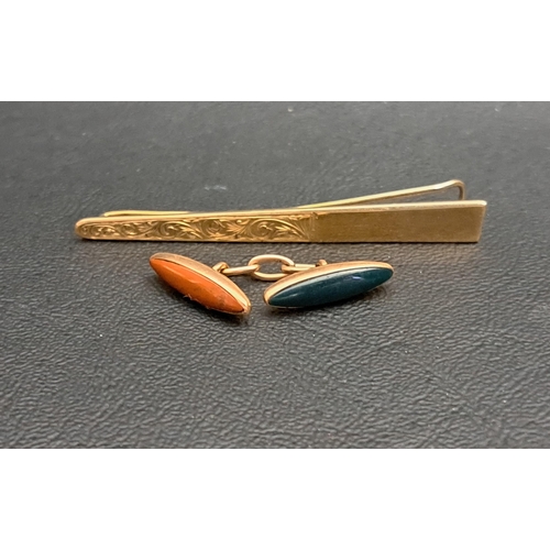 215 - NINE CARAT GOLD TIE SLIDE
with engraved scroll decoration, approximately 4.8 grams; together with a ... 