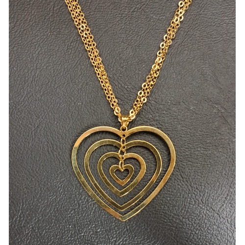 38 - NINE CARAT GOLD HEART PENDANT
formed with four graduated hearts suspended within each other, on trip... 