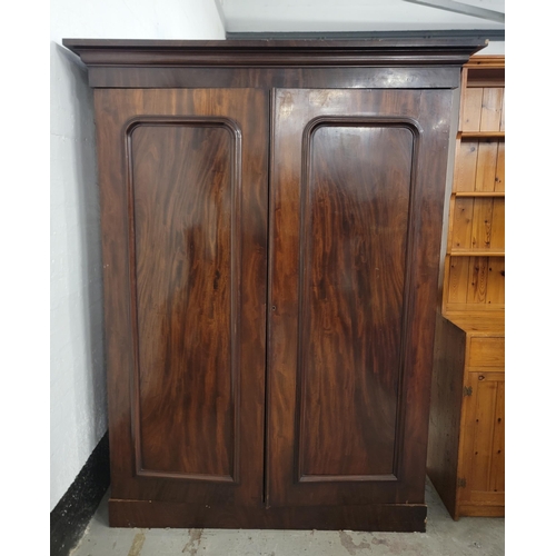 699 - MAHOGANY GENTLEMANS WARDROBE
with double doors opening to reveal a hanging rail to one side and five... 