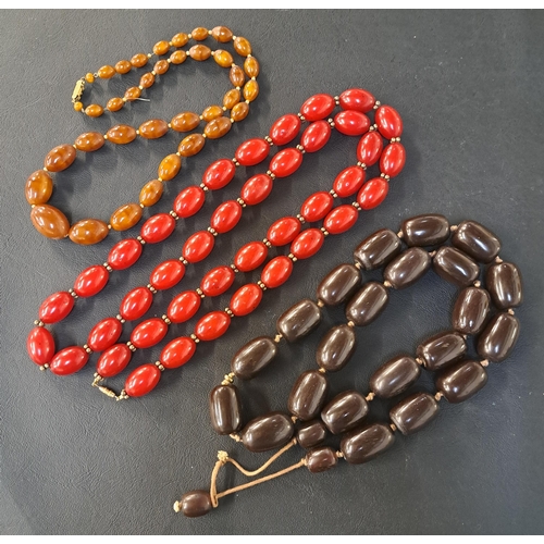 130 - THREE AMBER COLOURED BEAD NECKLACES
one of cherry amber colour, 108cm long and 132 grams; another of... 