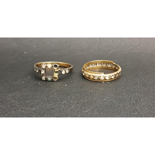 217 - CZ ETERNITY RING 
in nine carat gold, ring size N-O and approximately 1.6 grams; and a paste set nin... 