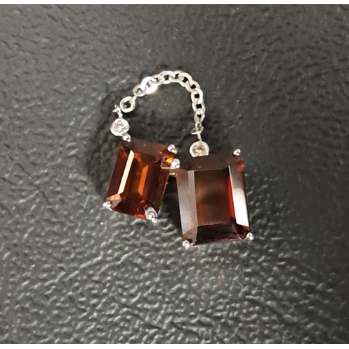 10 - GARNET AND DIAMOND PENDANT
the two rectangular cut garnets below small diamond chips with chain loop... 