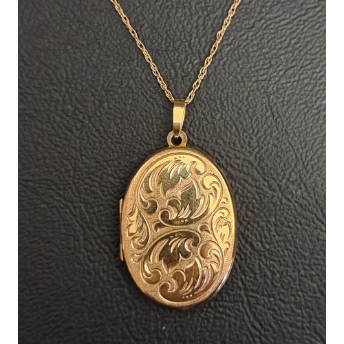 20 - NINE CARAT GOLD LOCKET PENDANT
the oval locket with engraved scroll decoration, on nine carat gold c... 