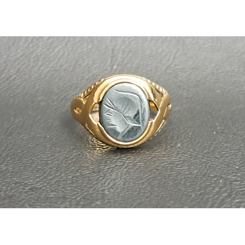 64 - HARDSTONE SEAL RING
the matrix depicting a stylised profile of a man in a hat, on nine carat gold sh... 