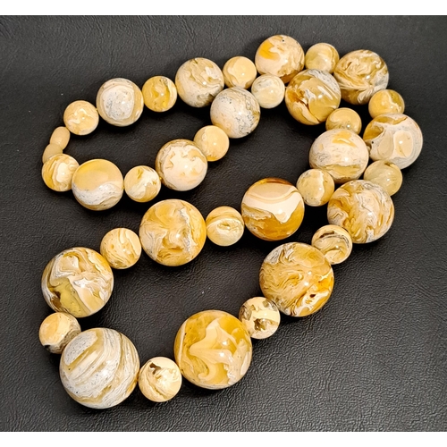 98 - GRADUATED AMBER AGATE BEAD NECKLACE
with alternating small and larger beads, 68cm long and 168 grams