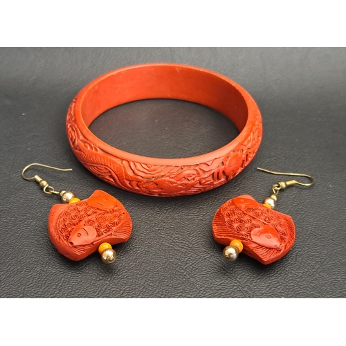 171 - CHINESE RED CINNABAR LACQUER BANGLE AND PAIR OF EARRINGS
the bangle with carved dragon decoration an... 