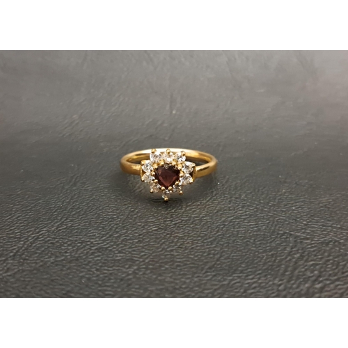 179 - GARNET AND CZ CLUSTER RING
the heart shaped garnet in CZ surround, on nine carat gold shank, ring si... 