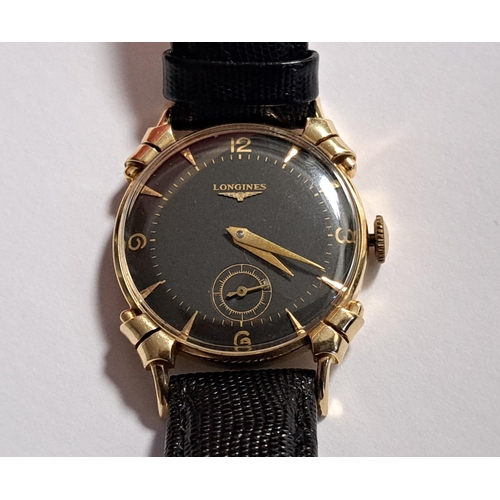 132 - GENTLEMAN'S LONGINES FOURTEEN CARAT GOLD CASED WRISTWATCH
circa 1950, the black dial with Arabic num... 