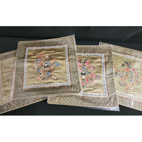 440 - FOUR CHINESE SILK EMBROIDERED CUSHION COVERS
all with colourful floral decoration to the centre (two... 