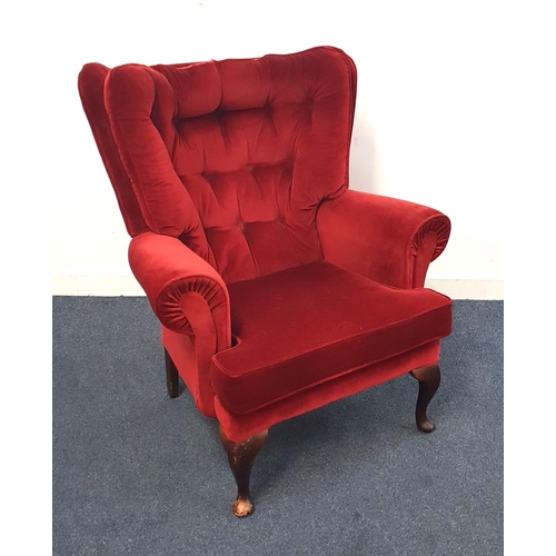 673 - RED VELVEL UPHOLSTERED WING BACK ARMCHAIR
with button back and raised on front cabriole supports, 85... 