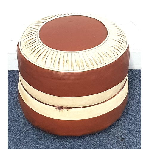 704 - MID-CENTURY STYLE VINYL POUFFE
in brown and cream, with four castors to the underside, 41cm in diame... 