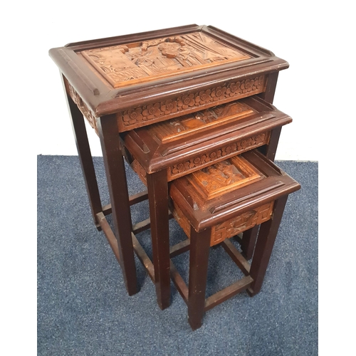 716 - NEST OF THREE ORIENTAL STYLE OCCASIONAL TABLES
with heavily carved tops depicting figures in interio... 