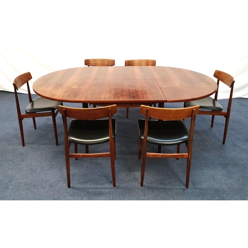 718 - A MID CENTURY DANISH ROSEWOOD EXTENDABLE DINING TABLE WITH SIX MATCHING CHAIRS
The table extended wi...