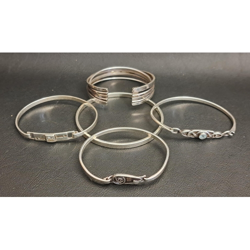 FIVE SILVER BANGLES
including a multi strand cuff bangle, a blue topaz set bangle with pierced Celtic detail, and two Mackintosh style bangles (5)