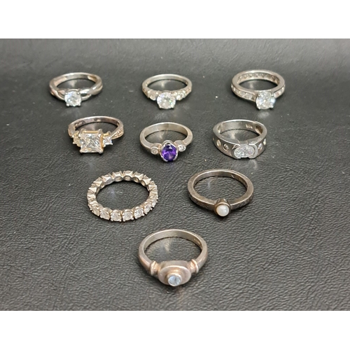 140 - NINE CZ AND OTHER STONE SET SILVER RINGS
including six set with CZ, one with blue topaz and another ... 