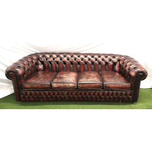 719 - VINTAGE FOUR SEATER LEATHER CHESTERFIELD SOFA
of a red brown colour with button back detail, raised ... 