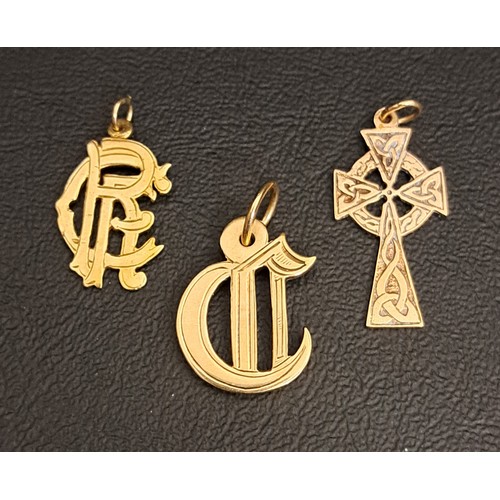 193 - THREE NINE CARAT GOLD PENDANTS
one in the form of a Celtic cross, another with monogram RFC and the ... 