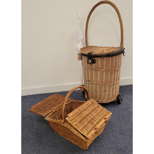 429 - WICKER SHOPPING TROLLEY
along with a wicker picnic basket, the trolley canvas lined and with umbrell... 