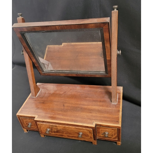 687 - GEORGIAN TOILET MIRROR
on three drawer base with marquetry detail, the mirror stand with fluting, 40... 