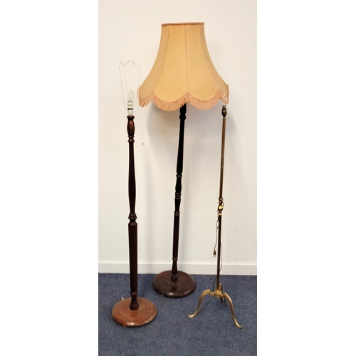 656 - THREE STANDARD LAMP STANDS
comprising two mahogany with turned columns on round bases and a brass fl... 