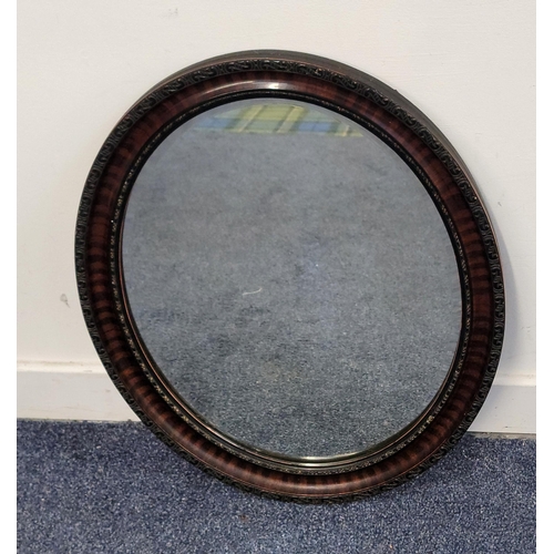 614 - VICTORIAN OVAL WALL MIRROR
with bevel edge and snakewood and ebonised frame with textured detail, 59... 