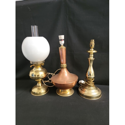 688 - BRASS DUPLEX OIL LAMP
with glass shade, 50cm high; together with a copper and brass table lamp and a... 