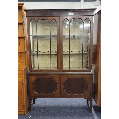 701 - EDWARDIAN MAHOGANY DISPLAY CABINET 
the glazed doors revealing damask covered shelves, above two cup... 