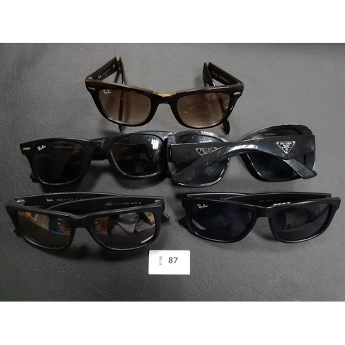 87 - FIVE PAIRS OF DESIGNER SUNGLASSES
comprising 4 pairs of Ray-Ban sunglasses (one folding pair), and o... 