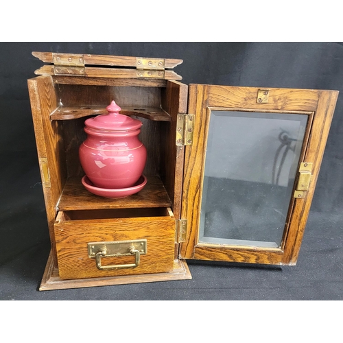 381 - EARLY 20th CENTURY OAK SMOKERS CABINET
with a lift up lid, the interior with pipe rack, light plum c... 