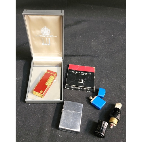 380 - SELECTION OF LIGHTERS
consisting of cased red and gilt Dunhill lighter, a Zippo, a miniature blue zi... 