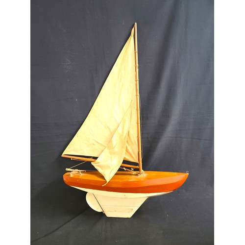 451 - PAINTED WOODEN POND YACHT
with teak decking and red and white hull, with rigging, 104cm high includi... 