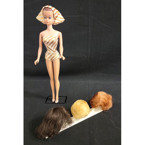 458 - 1960s VINTAGE BARBIE FASHION QUEEN WITH WIGS
Barbie in gold and cream striped swimsuit with matching... 