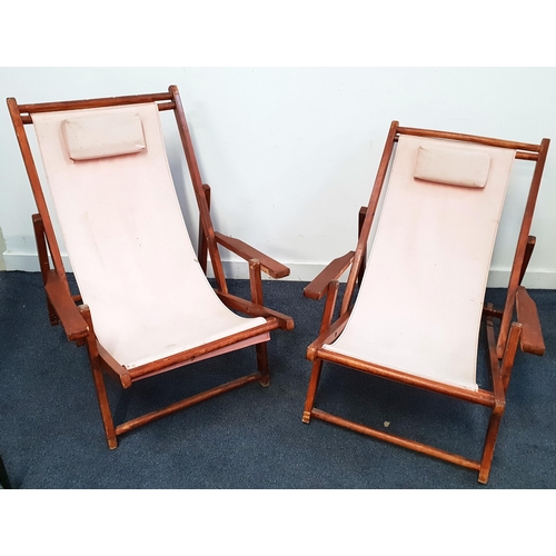 660 - TWO STAINED WOOD VINTAGE DECK CHAIRS
with pink canvas seats and attached head cushions