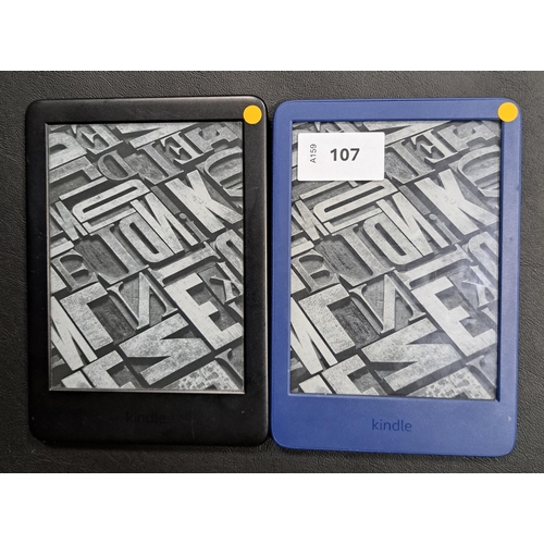 107 - TWO AMAZON KINDLE E-READERS
comprising a Basic 4, serial number G092 AQ05 4133 06H1; and a Basic 3, ... 