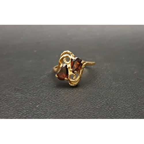 58 - GARNET TWO STONE RING
on ten carat gold shank with pierced setting, ring size O and approximately 2.... 